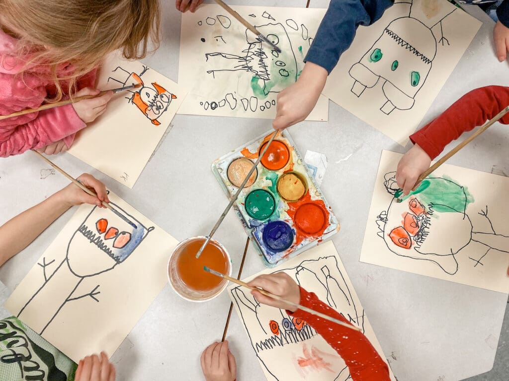 students painting during the kindergarten flow of the day