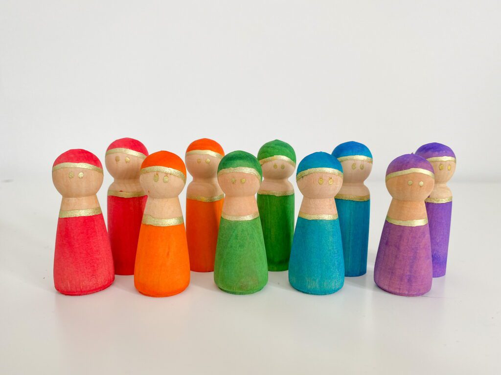 Peg people that have been dyed using liquid watercolour.