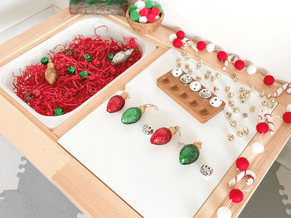 This Christmas sensory bin focuses on making patterns. Fill one bin with different manipulatives and have kids use the Christmas ornaments to count and make patterns!