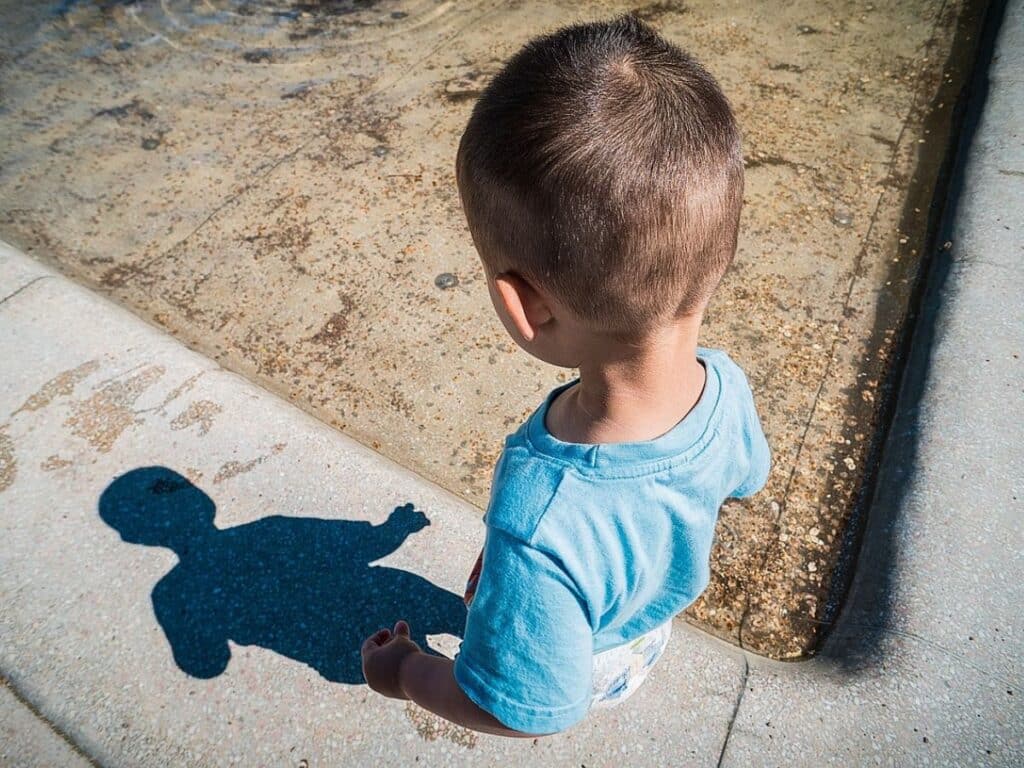A child is measuring his shadow to measure the movement of the sun for their daily and seasonal changes unit