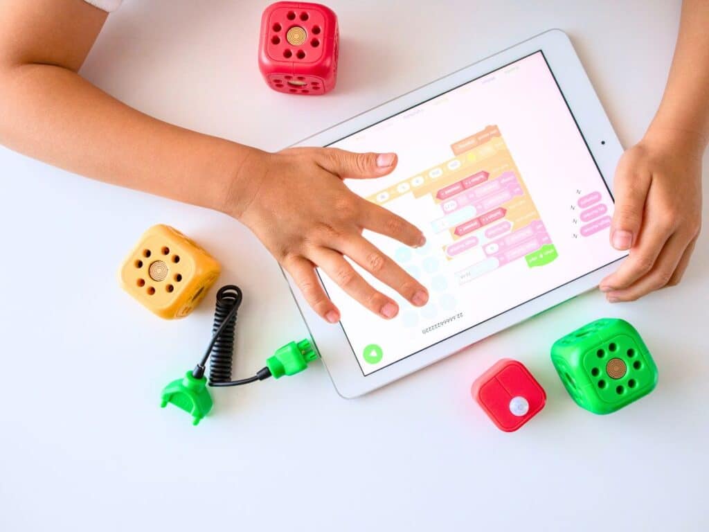 A child using ScratchJr on an ipad to practice Coding