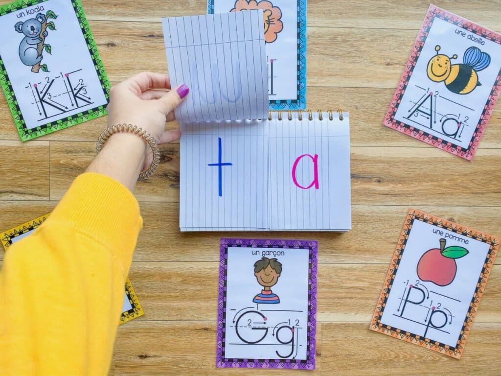 French science of reading activities to practice reading syllables in a notebook.