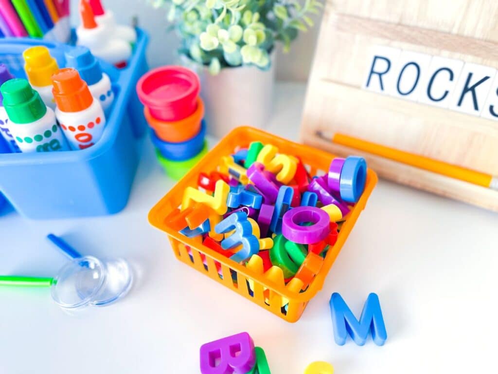 A basket with magnetic letters, used to make words. 