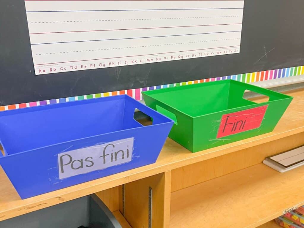 Two bins on a shelf for finished work and unfinished work in the classroom